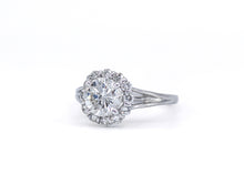 Load image into Gallery viewer, Side view of a white gold Verragio engagement ring featuring a GIA certified round brilliant-cut center diamond surrounded by a diamond halo, with a split shank set on a white background.