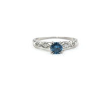 Load image into Gallery viewer, Vintage platinum ring set in the center with a color enhanced fancy blue round diamond, with white diamond side stones.