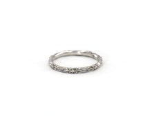 Load image into Gallery viewer, 14K white gold wedding band featuring beautifully carved flowers in an eternity style.