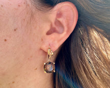 Load image into Gallery viewer, Vintage 14K yellow gold drop earrings featuring large round smokey quartz gemstones in a free form four-prong setting with lever-back clasps, displayed on a person.