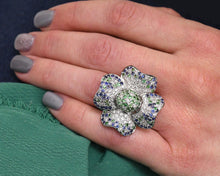 Load image into Gallery viewer, 18K white gold diamond, blue sapphire, and green garnet flower cocktail ring.