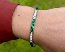 Load image into Gallery viewer, Synthetic Emerald And Diamond Line Bracelet Worn on a Wrist.
