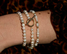Load image into Gallery viewer, A collection of Pearl Strand Bracelets on a wrist
