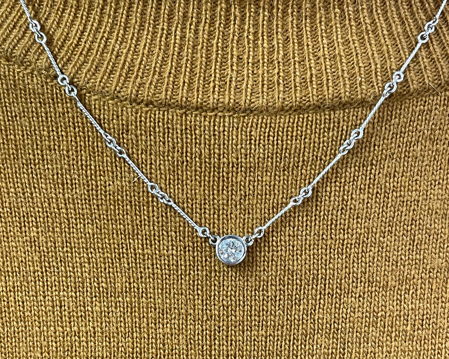 14K white gold diamond solitaire pendant necklace featuring a 0.40CTS H-I1 round brilliant cut diamond.