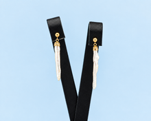 Load image into Gallery viewer, Product photo of a long vintage dangler earring featuring a 14K yellow gold ball stud and decorative cup holding a slender, elongated natural-shaped white pearl.

