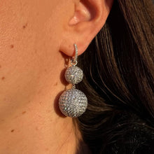 Load image into Gallery viewer, Close-up of a person wearing sparkling diamond disco ball earrings.
