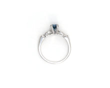 Load image into Gallery viewer, Vintage platinum ring set in the center with a color enhanced fancy blue round diamond, with white diamond side stones.
