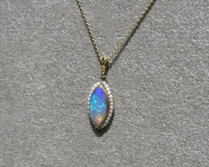Vintage 14K yellow gold opal and seed pearl pendant necklace side view.