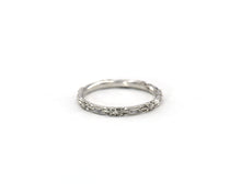 Load image into Gallery viewer, 14K white gold wedding band featuring beautifully carved flowers in an eternity style.

