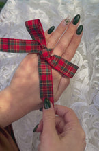 Load and play video in Gallery viewer, Vintage 2.65CT Round Brilliant Cut Diamond Solitaire Engagement Ring Being Revealed Under a Plaid Ribbon Bow.
