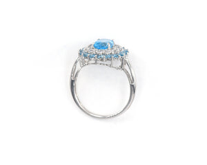 10k white gold, blue topaz and white sapphire halo cocktail ring.