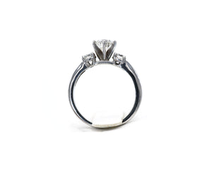14k white gold three stone round brilliant cut diamond engagement ring.