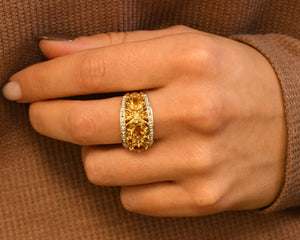 14k yellow gold ring set with citrines and diamonds on hand.