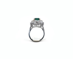 Estate 18K white gold ring set with emerald and diamonds.