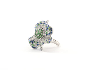 18K white gold diamond, blue sapphire, and green garnet flower cocktail ring.