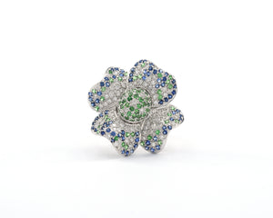 18K white gold diamond, blue sapphire, and green garnet flower cocktail ring.