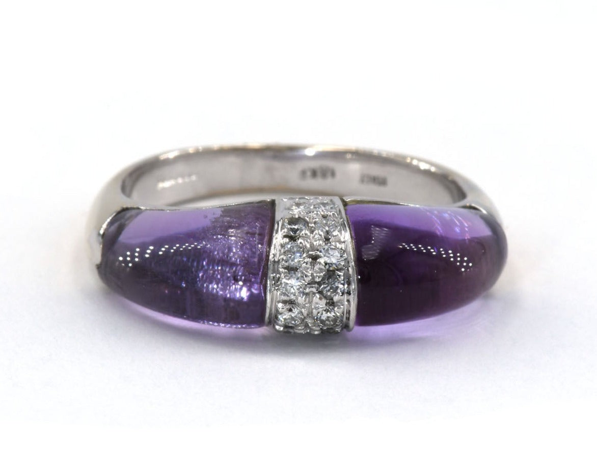 This 18k white gold statement ring features two fancy-shaped cabochon cut amethyst separated by a dome of pave diamonds.