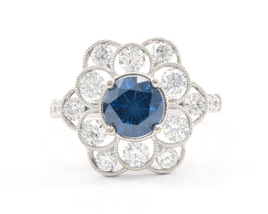 18K white gold fancy blue and white diamond flower ring.