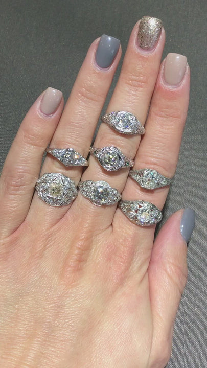 Vintage diamond rings modeled on a hand.